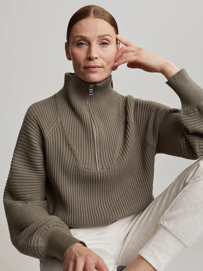 woman wearing a sage green sweater