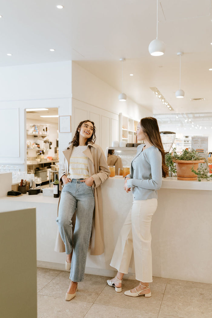 woman talking to friend in cafe