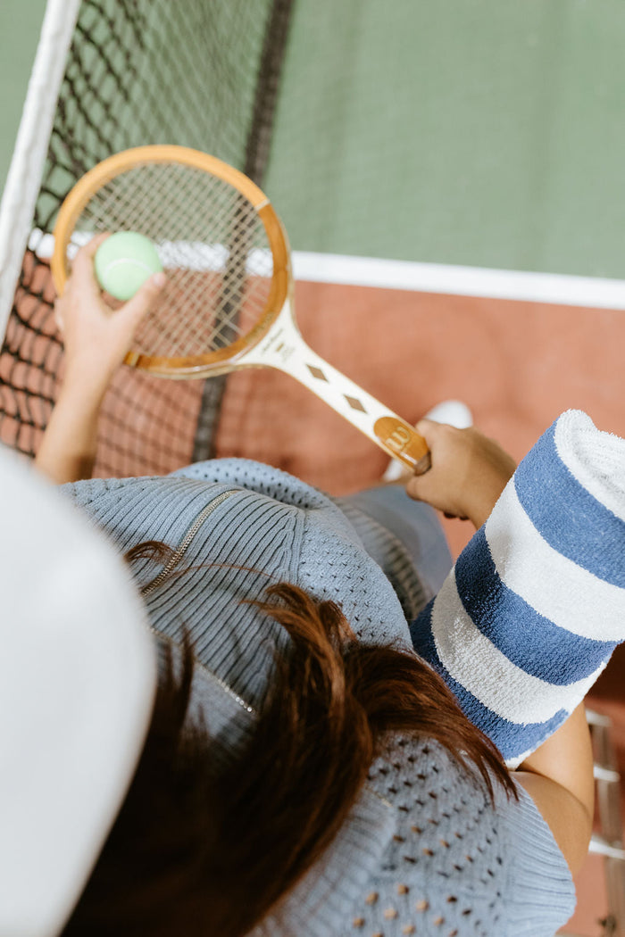 photo from above of a woman holding a tennis racket 